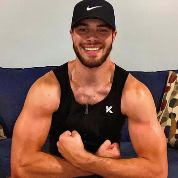 Guy posing at the couch in Kewlioo sweat sauna vest